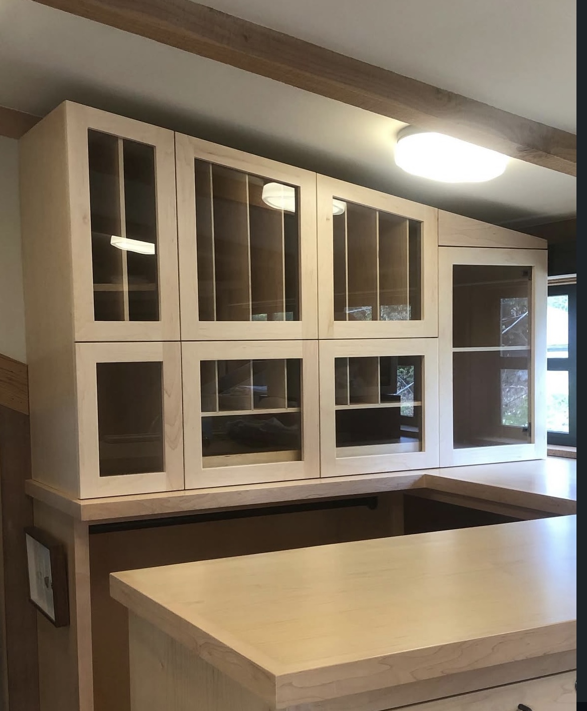 Custom maple kitchen cabinets with glass doors