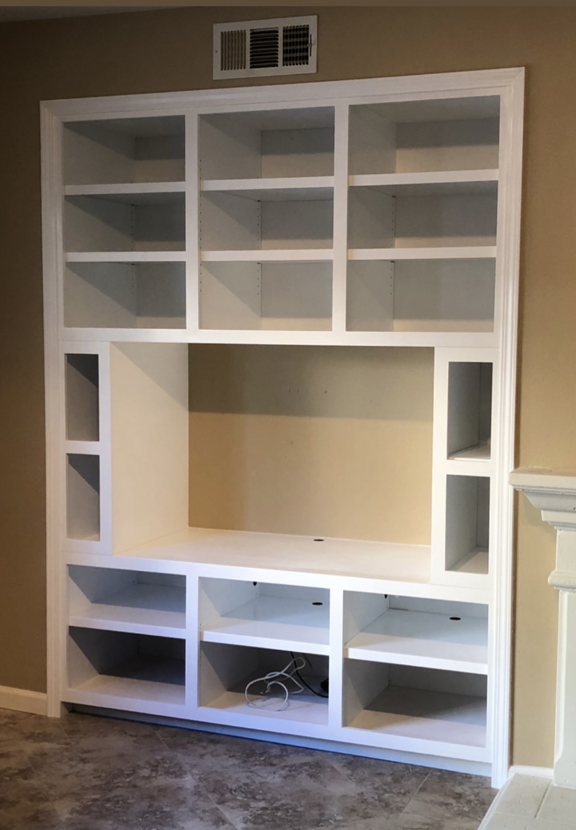 Custom entertainment center San Francisco — floor-to-ceiling white built-in media wall
